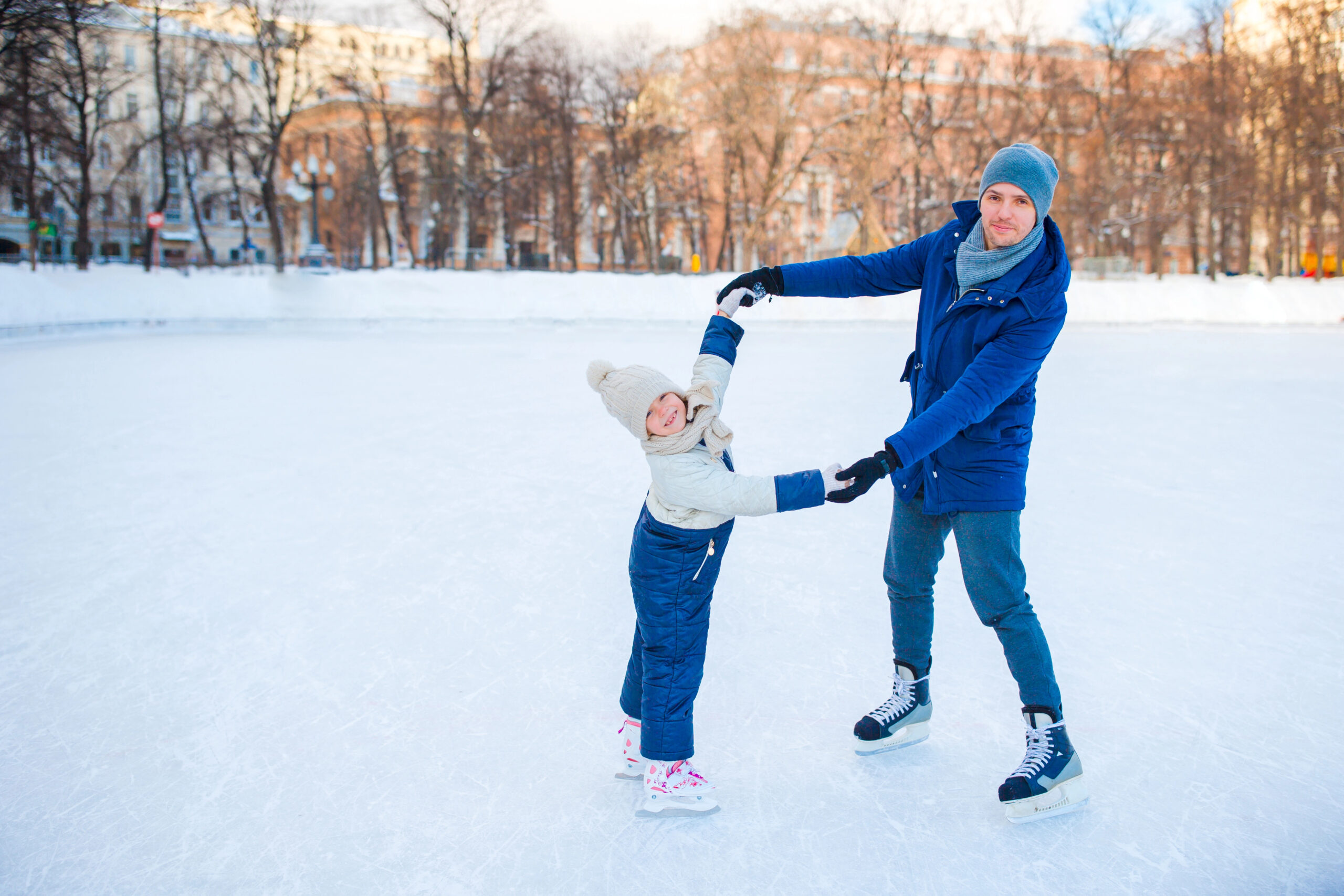 Certified ice skating instructor teaching a student on the rink